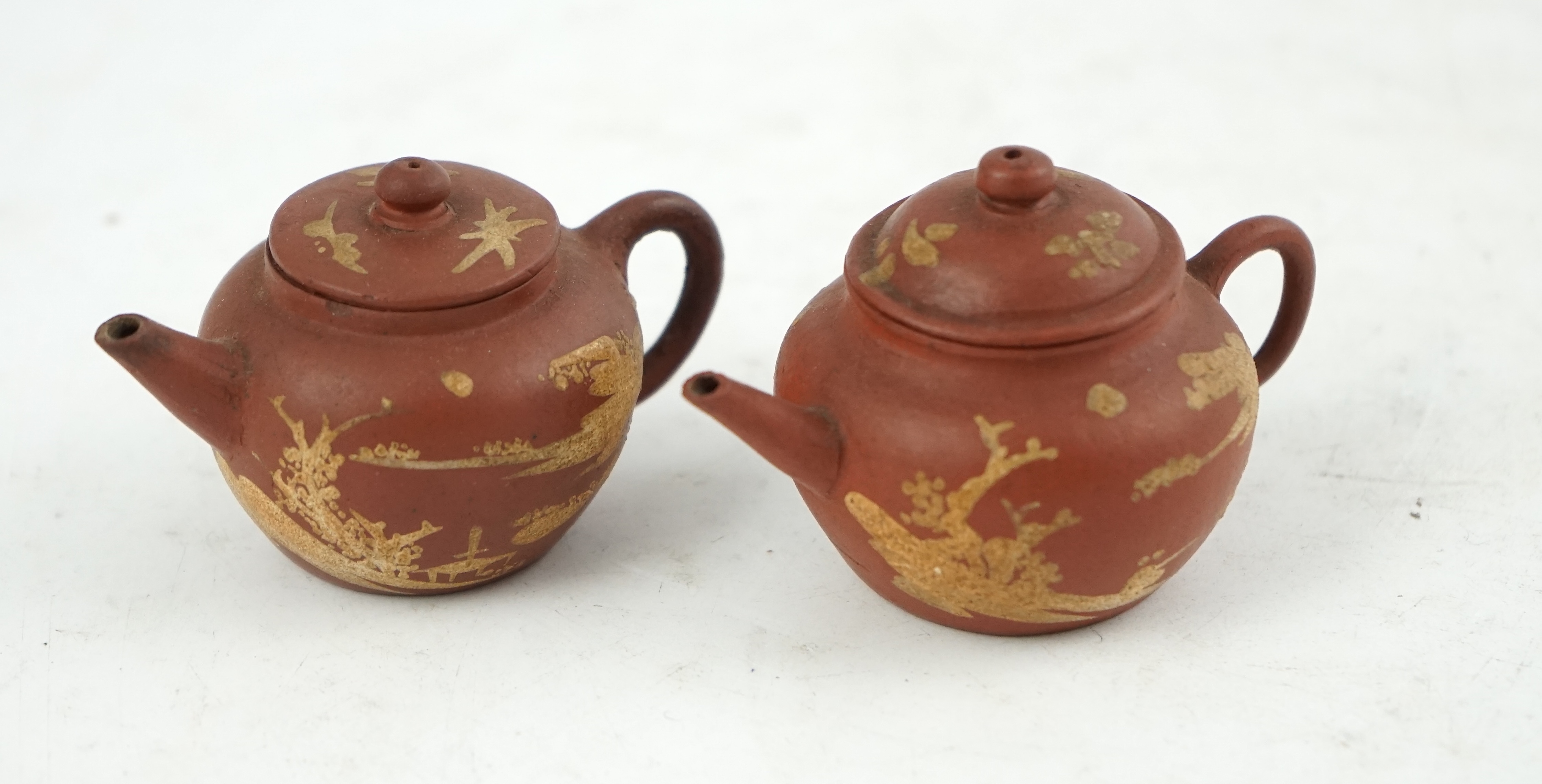 Two Chinese Yixing slip-decorated miniature teapots and covers, 18th/19th century